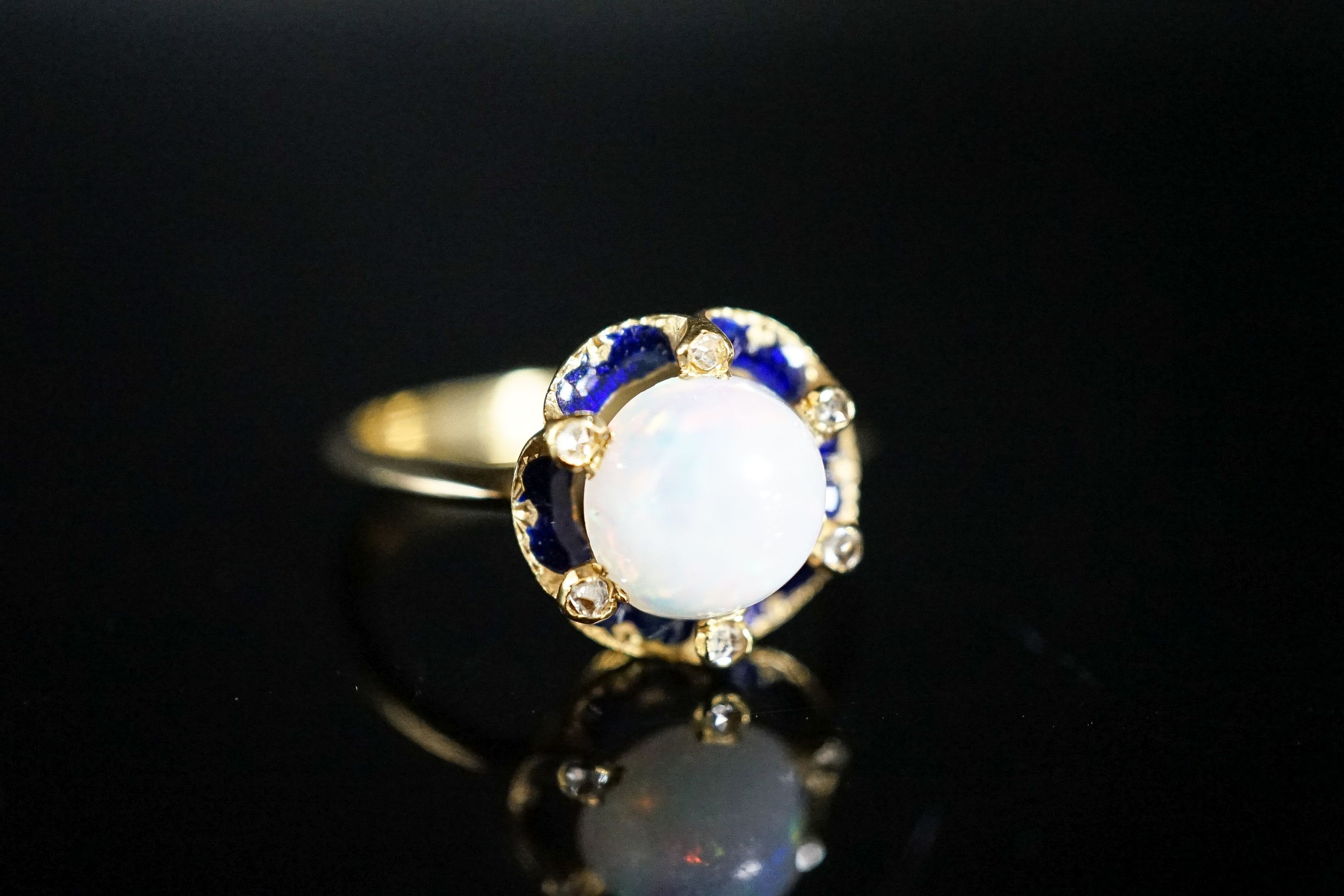 An 18ct, blue enamel, diamond chip and opal set dress ring, size R, gross weight 4.3 grams.